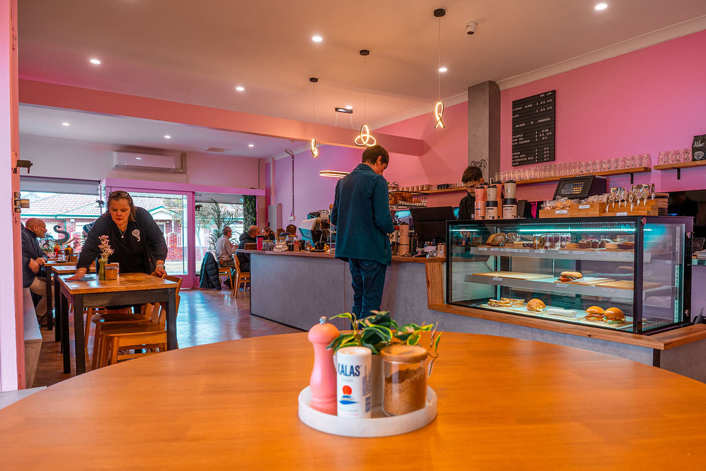 Warm, cosy seating and the coffee bar — the pink room the neighbourhood knows.